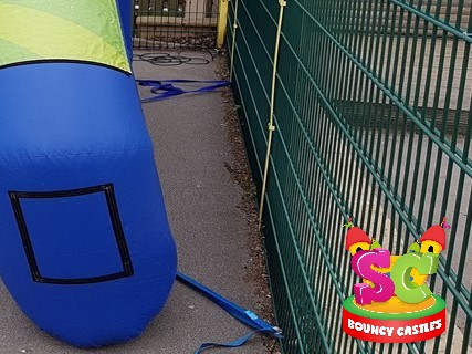 Photo of securing a castle to a fence with straps Securing a castle with straps